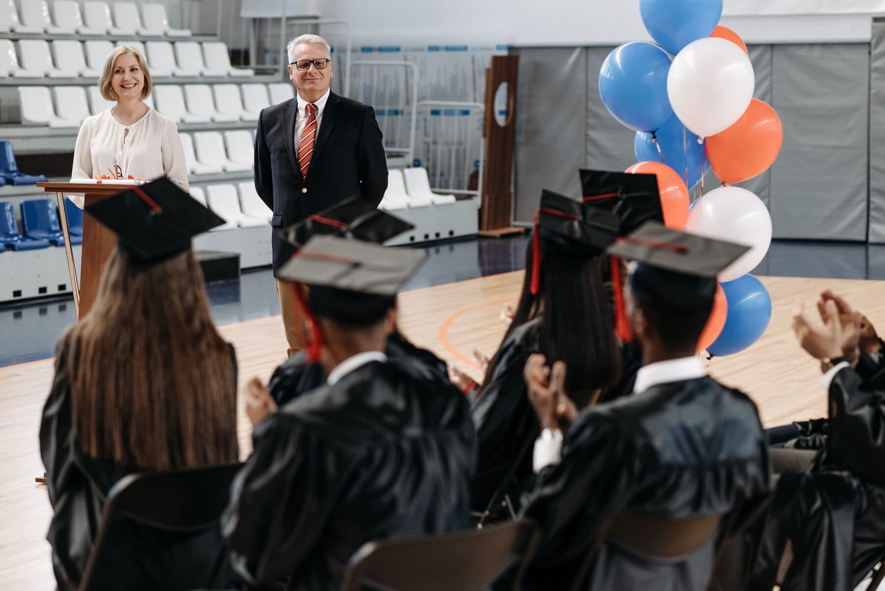 Graduates seated in a hall during a ceremony