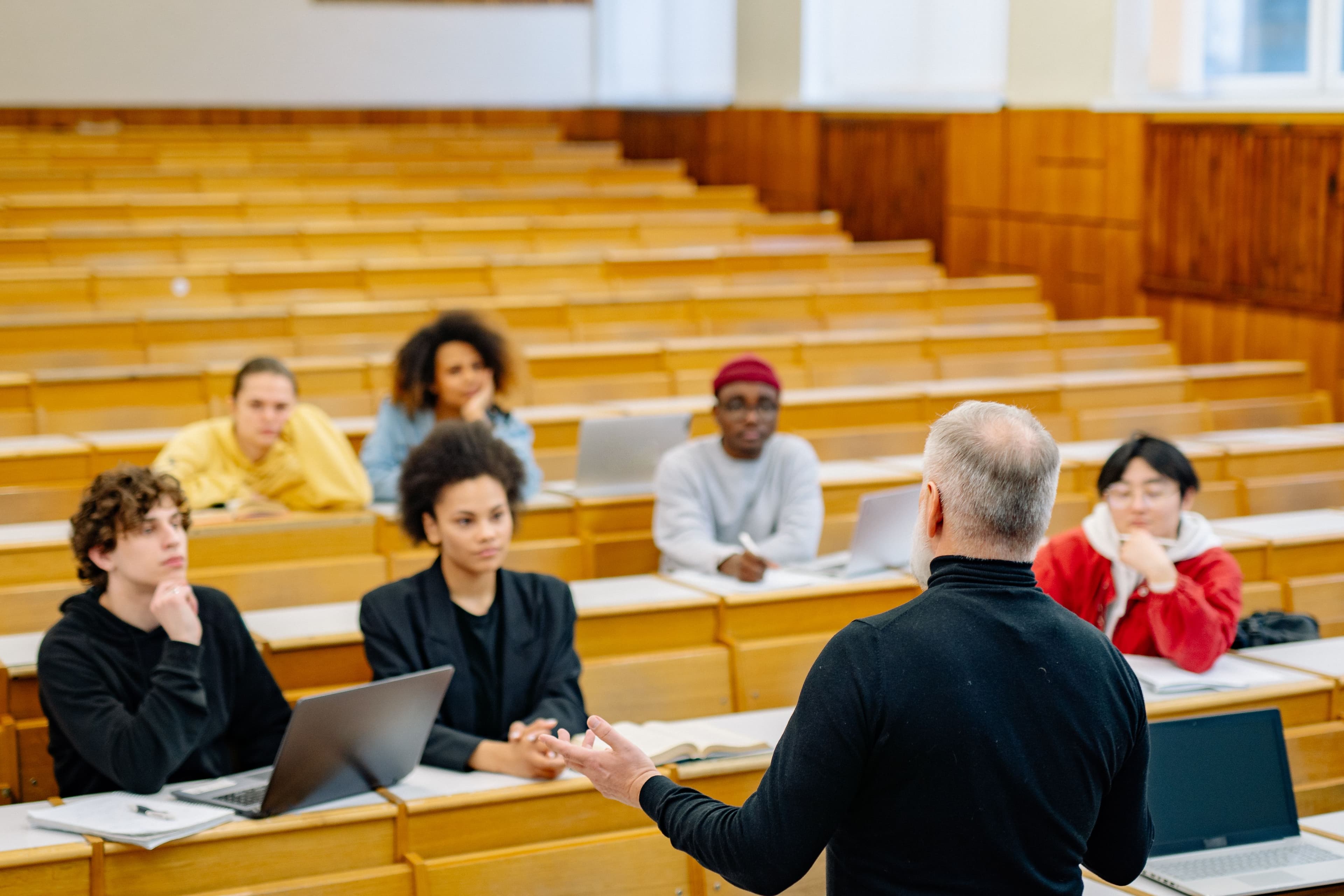 Adult students listening to an instructor in an evening classroom