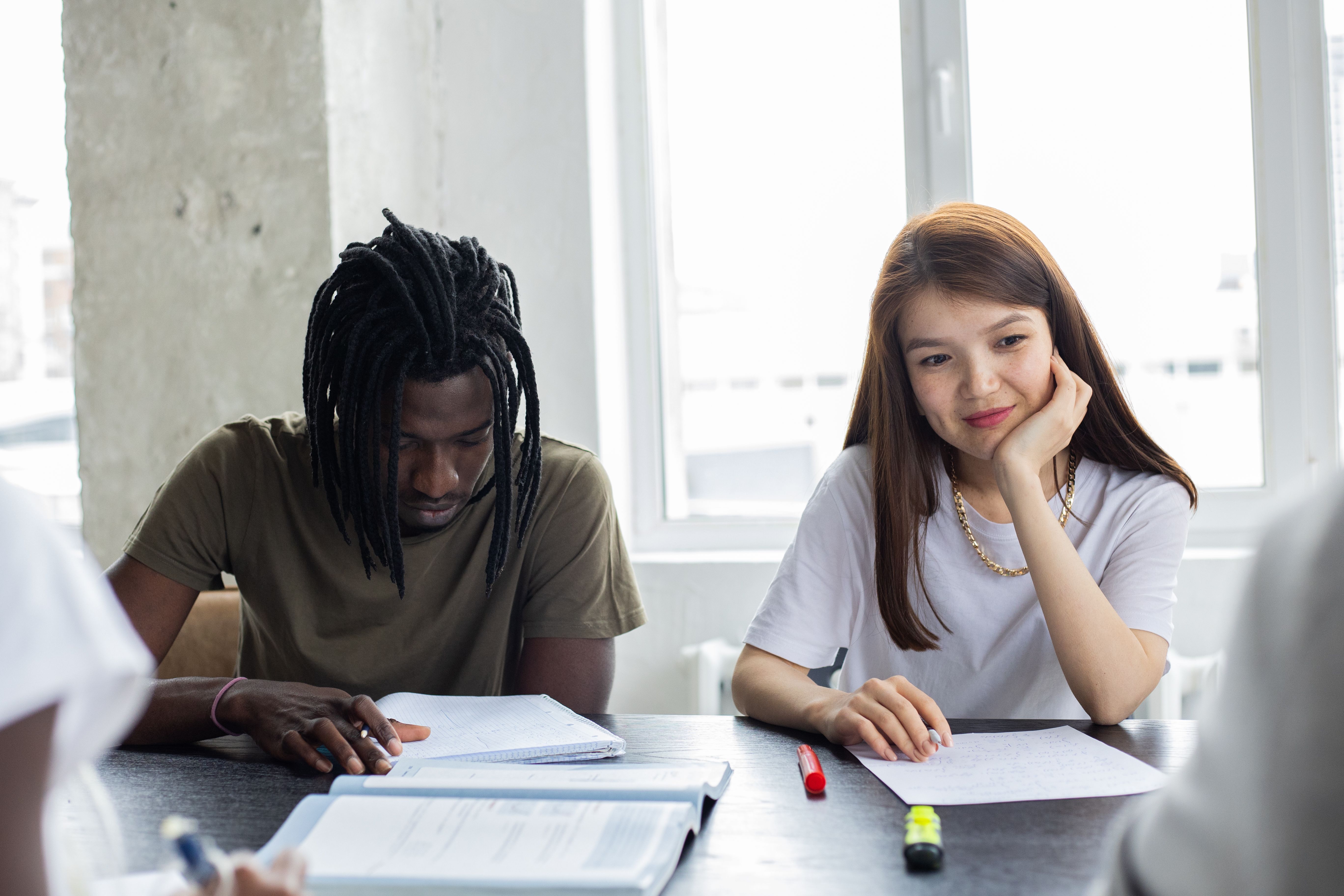 Classmates sitting around a table discussing coursework